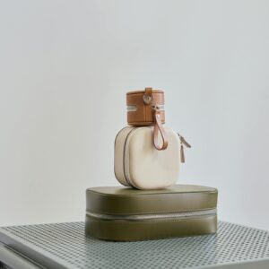 Assorted small handbags on a metal cabinet with a sleek, minimalist style.