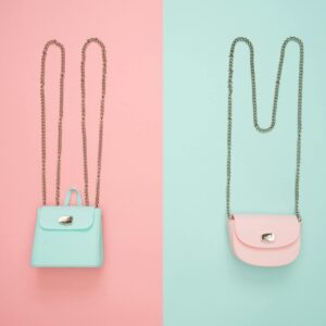 Stylish pastel handbags on pink and mint split backgrounds, perfect for fashion and design themes.